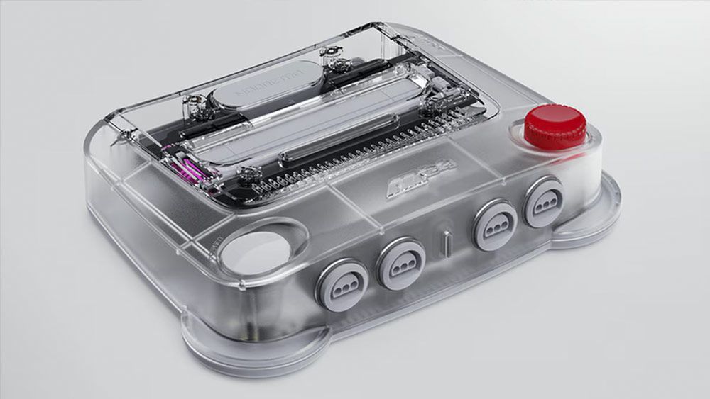 Consola de videojuegos Modretro M64 con carcasa transparente que permite ver los circuitos internos y botón de encendido rojo.