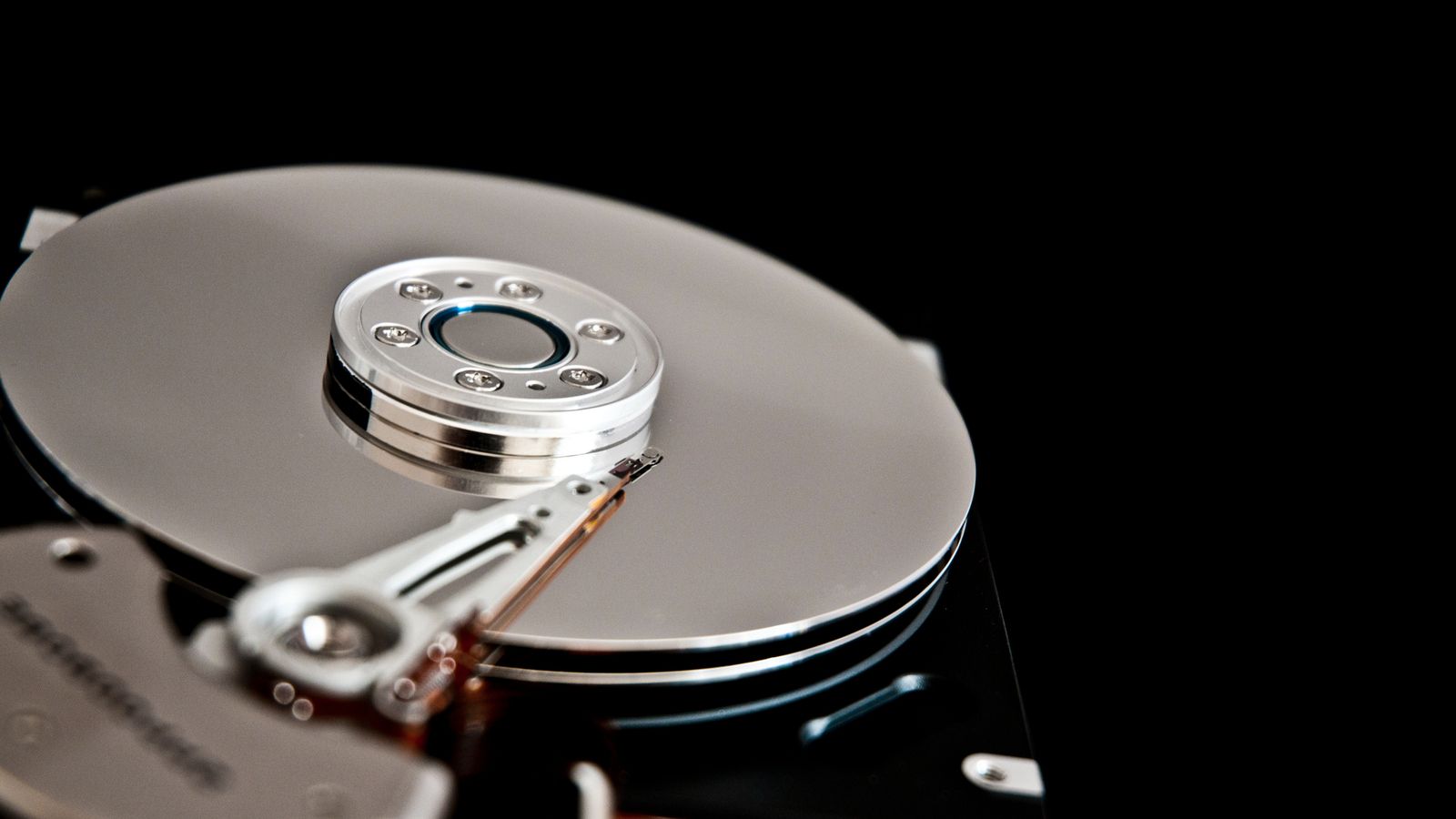 Cuerpo de disco HDD en buen estado sobre fondo negro.