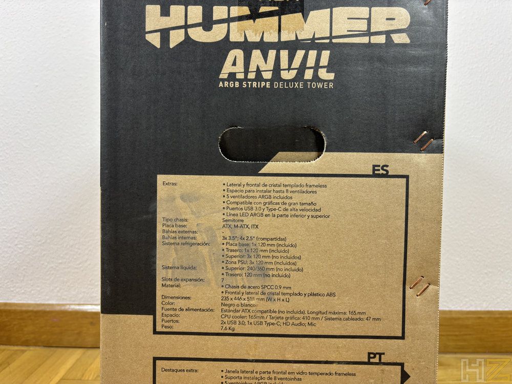 Caja de ordenador Nox Hummer Blade con paneles de cristal templado frontales y laterales montada sobre suelo de parqué, mostrando ventiladores con iluminación RGB violeta y una tira LED inferior en funcionamiento.