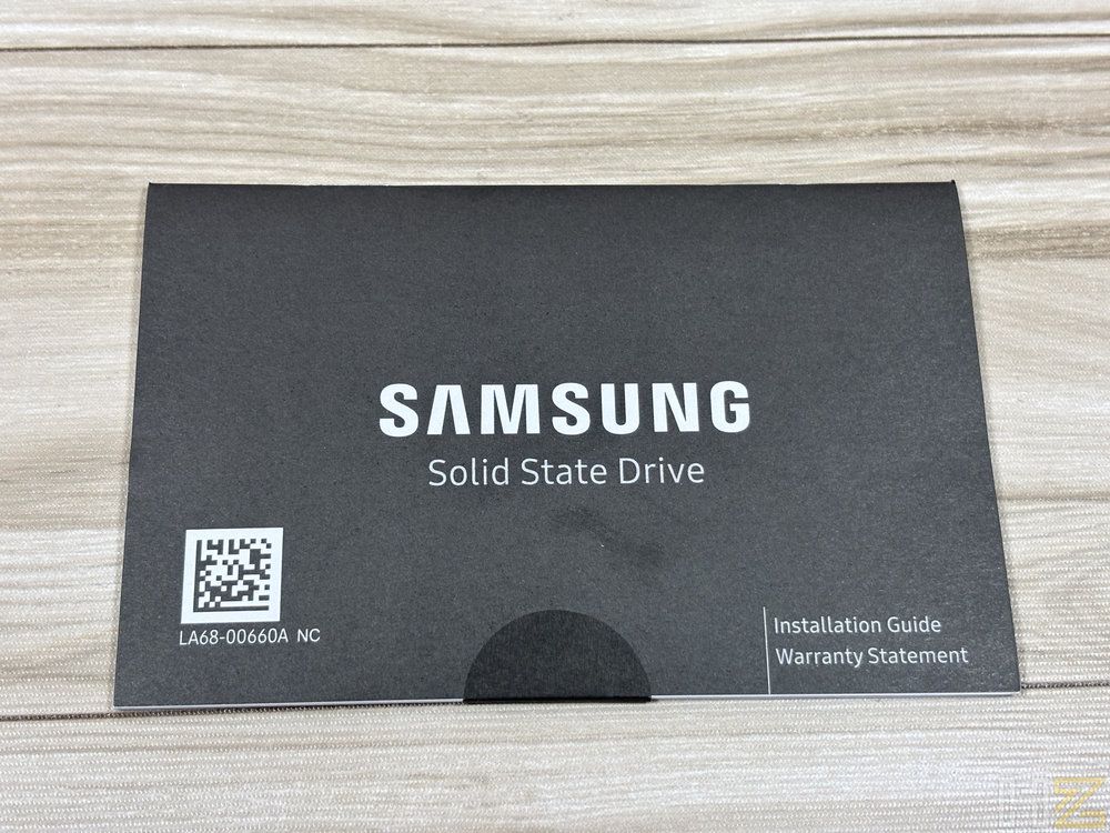 Manual de instrucciones y declaración de garantía de un disco de estado sólido Samsung sobre una superficie de madera clara.